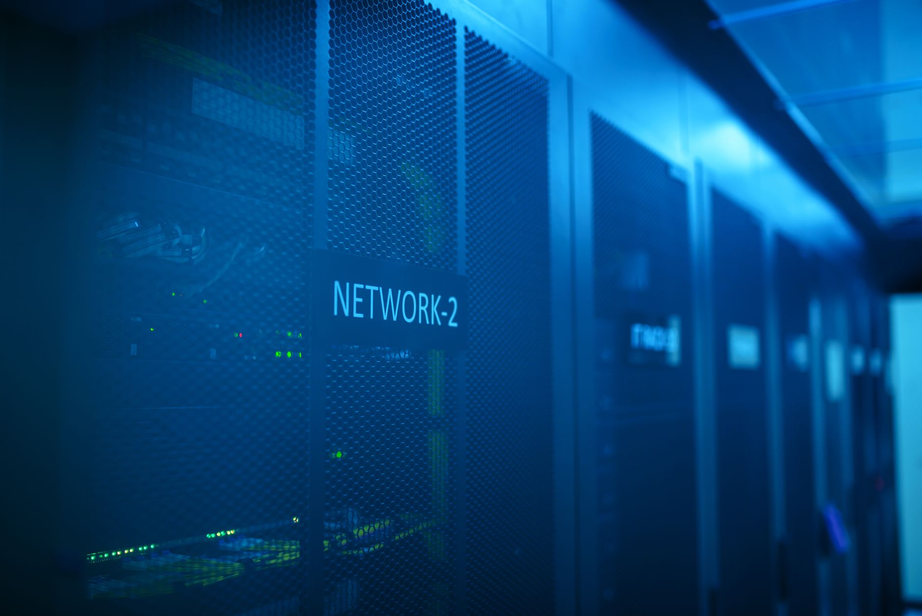 Server racks glowing blue in a modern data center.