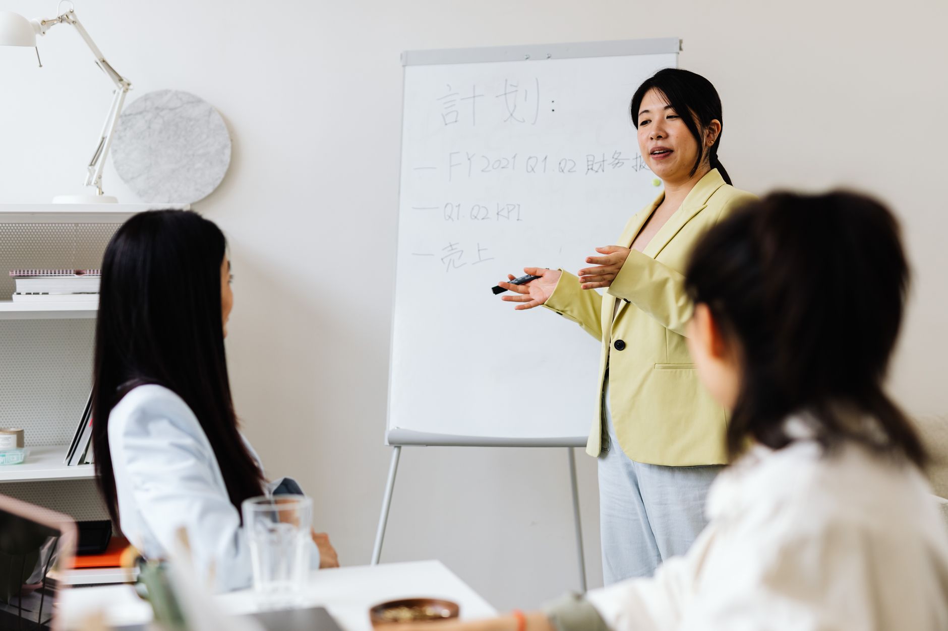 A presenter walks a team through a strategy session in a bright office.