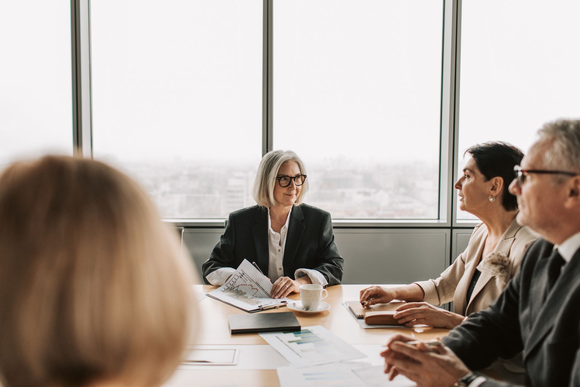 A leadership team works through strategy together in a modern boardroom.