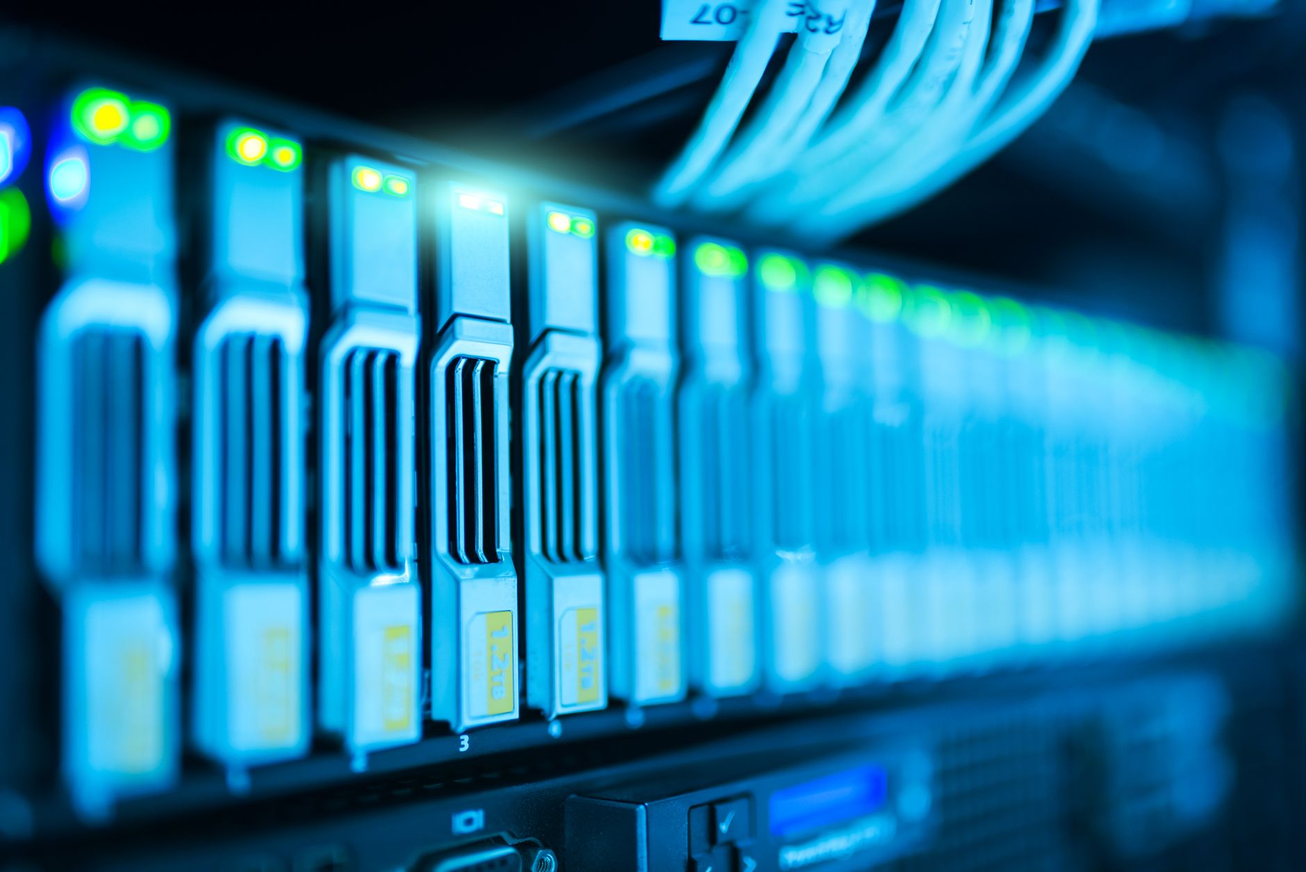 energy-hyperscale-racks Rows of high-density server racks glow inside a large data center.