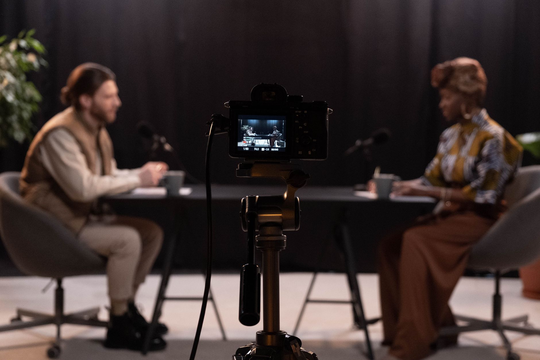media-podcast-studio Two hosts record a podcast episode in a studio with professional microphones.