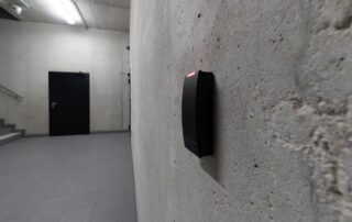 Electronic access control terminal mounted on concrete wall in secure facility