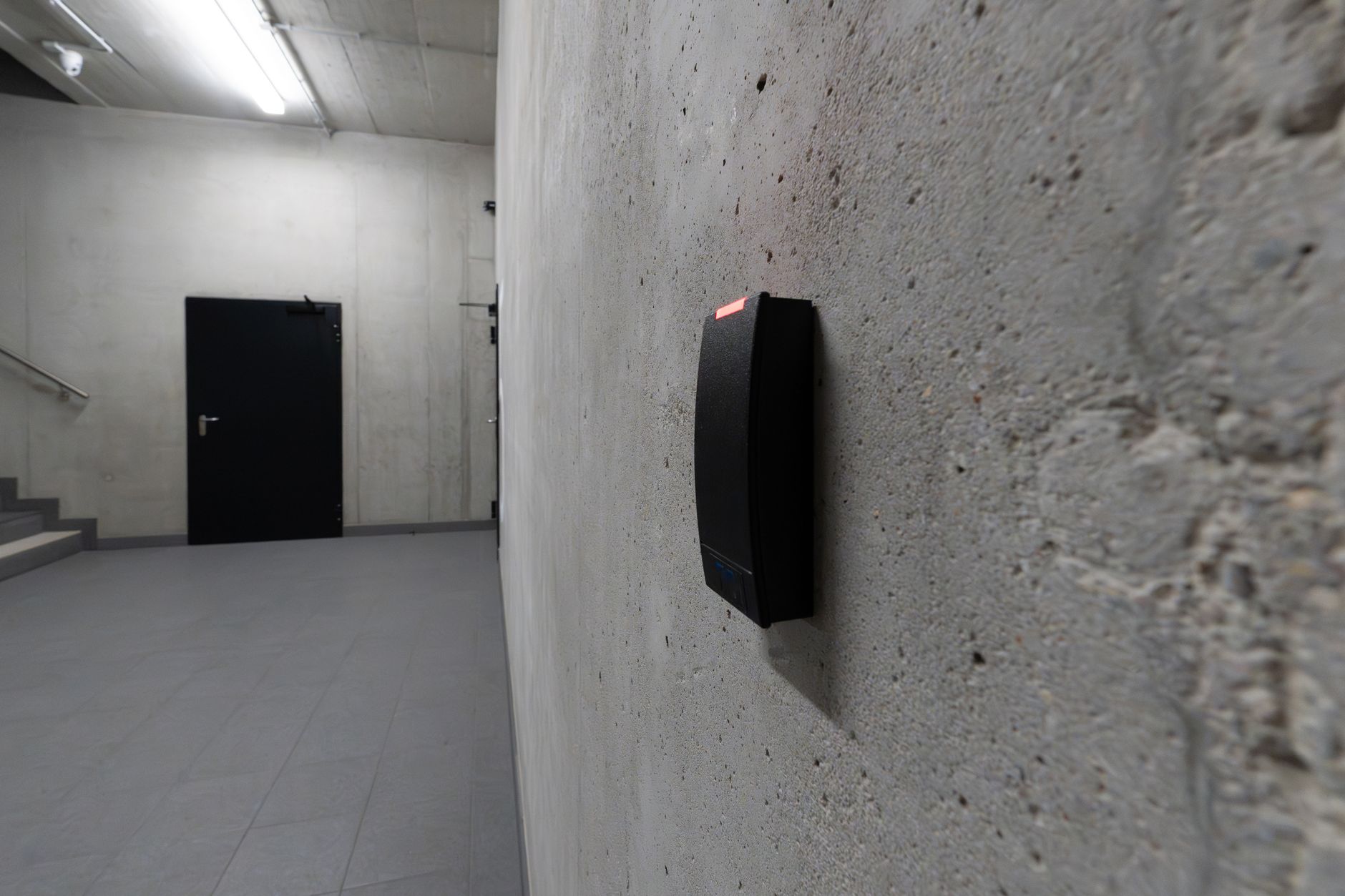 Electronic access control terminal mounted on concrete wall in secure facility