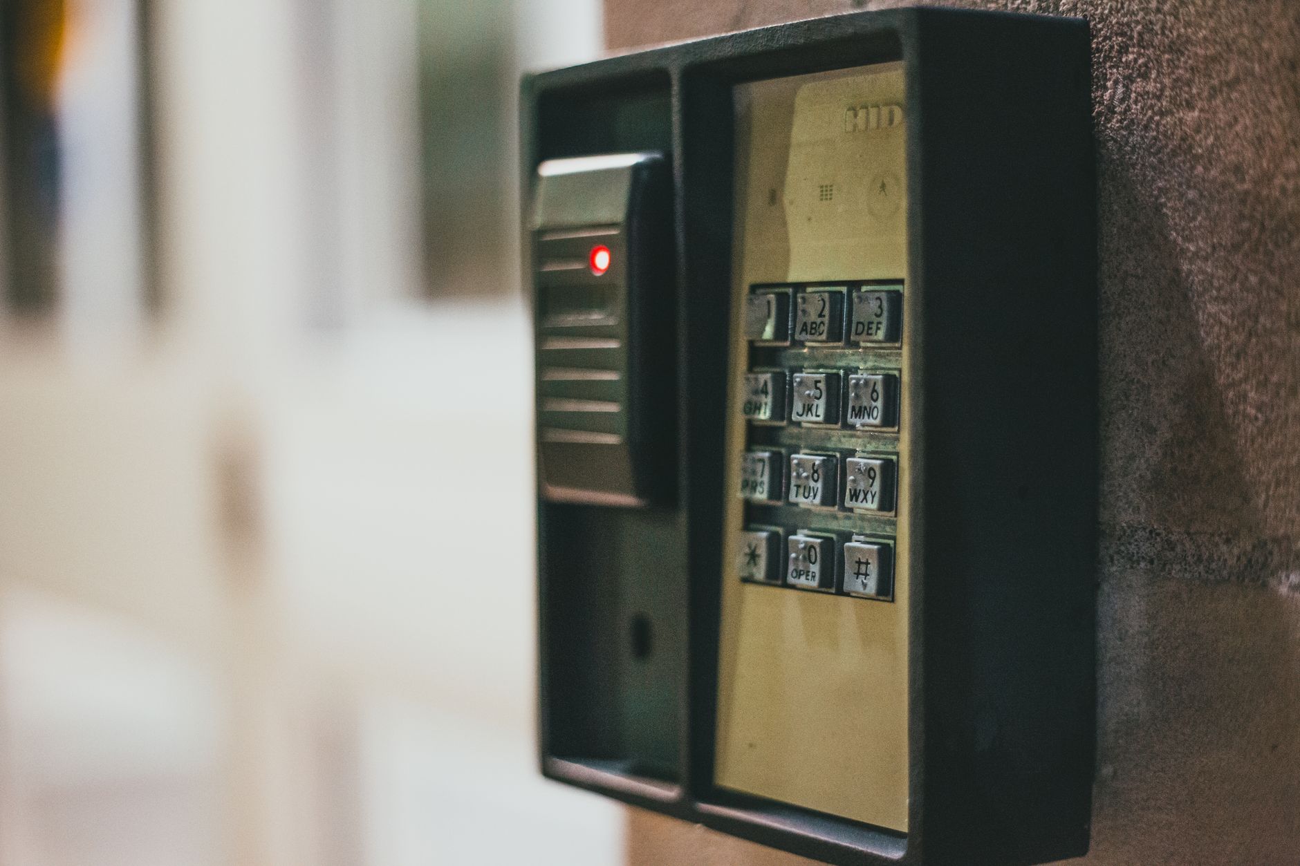 Illuminated security keypad mounted on wall for keyless entry access control