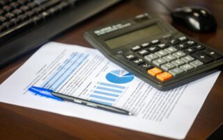 Desk with calculator, financial report, and pen for business analysis